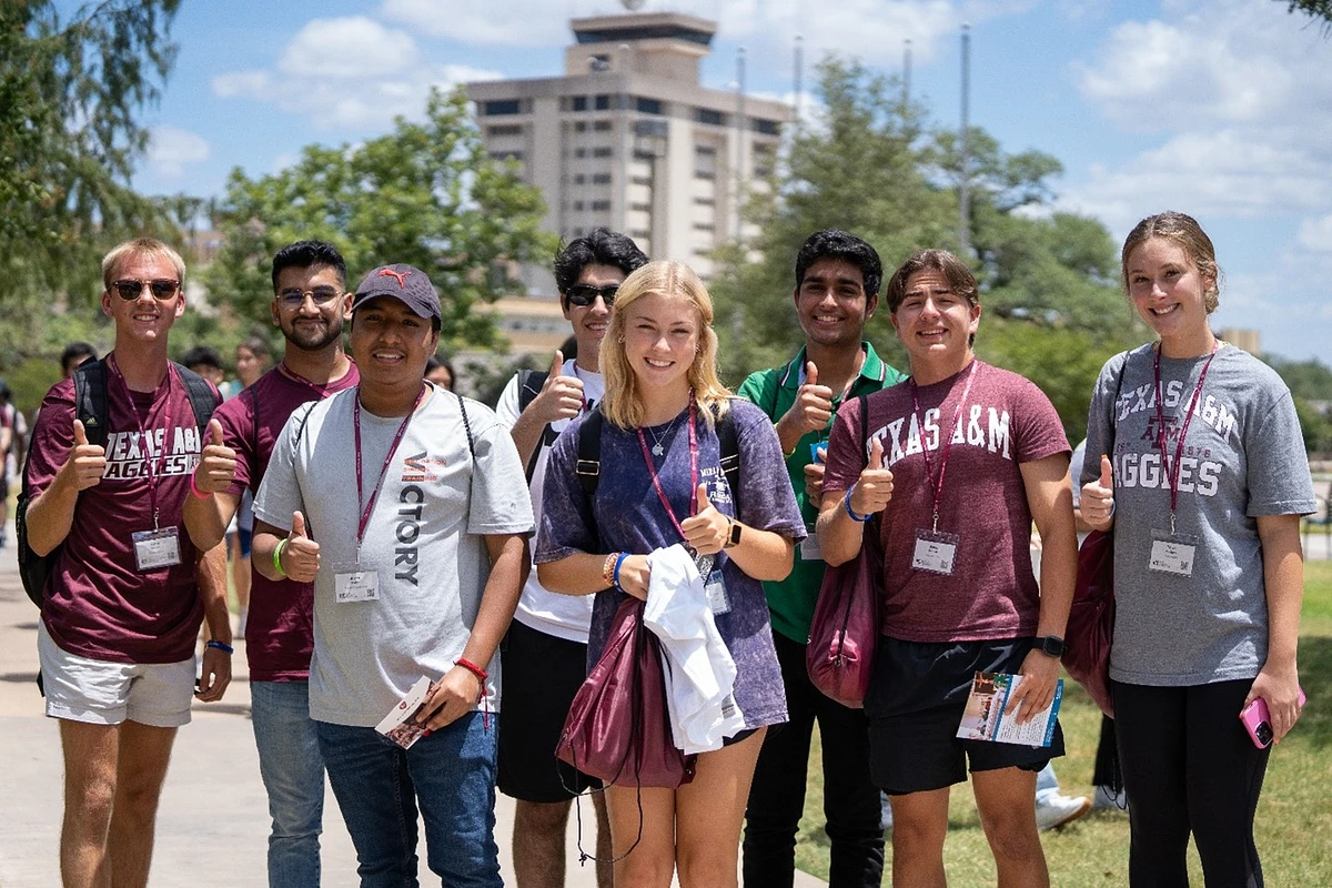 Eight students standing together with a gig ‘em 