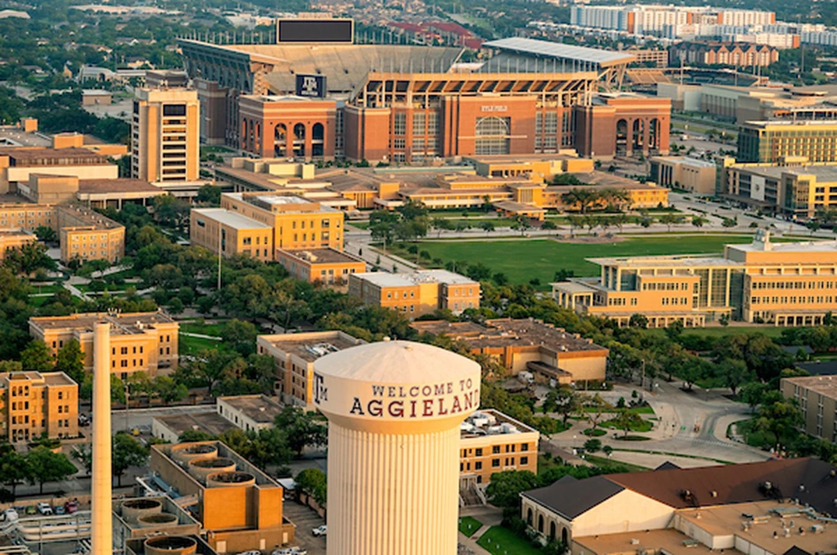 Aerial of Texas A&M University’s campus with “Welcome to Aggieland” on the water tower prominently 