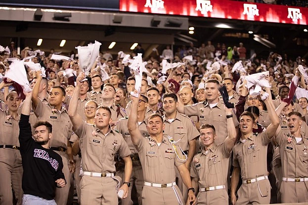 A group of students in their Corps of Cadets uniforms at a Texas A&M football game