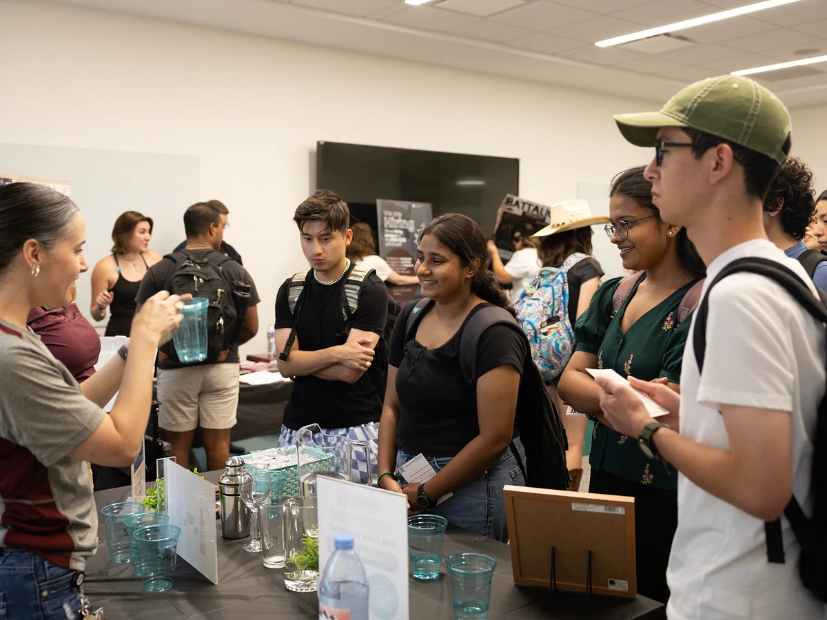 Students participate in an Alcohol and Other Drug education activity at the Student Life Open House, learning about standard alcoholic drink sizes.